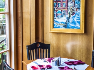 Cafe table by the window and a painting Cafe table by the window and a painting