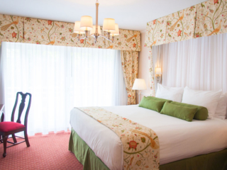 Deluxe King overview, white curtains and floral patterns
